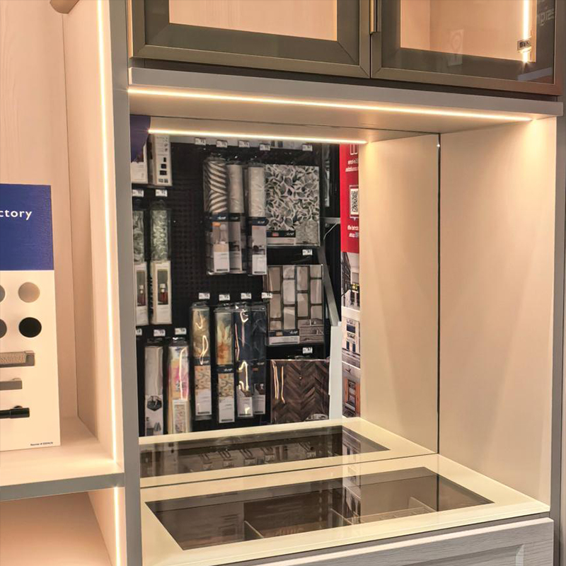 Illuminated wardrobe storage sections with glass-fronted cupboards and drawers