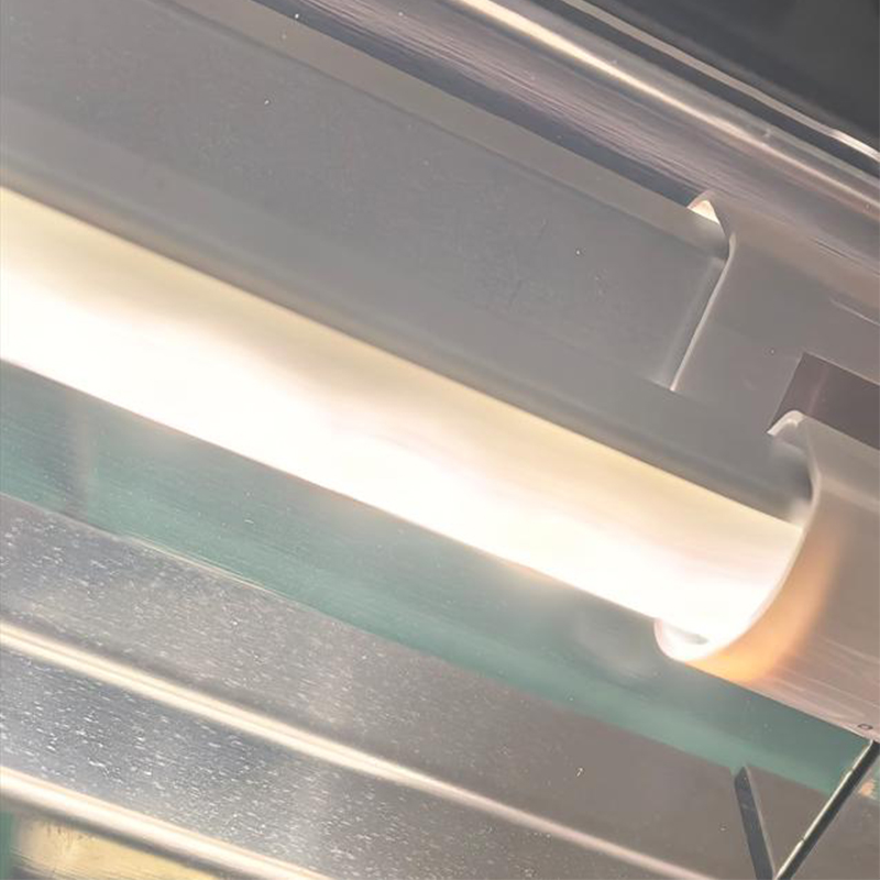Close-up of an illuminated LED light bar mounted beneath a refrigerated display shelf