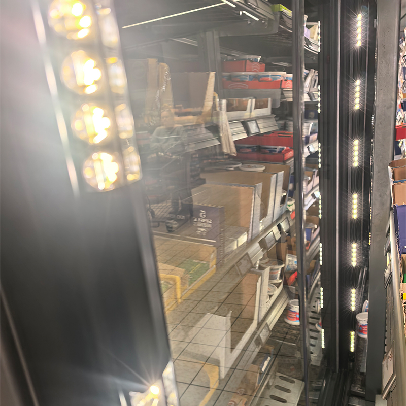Illuminated vertical LED light bars inside a glass-door freezer cabinet
